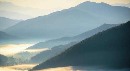 Fototapeta premium Misty mountain sunrise with layered hills panorama