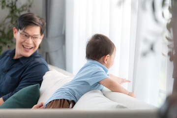 Fototapeta premium Father and son play together after dad comes home from work
