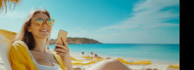 Obraz premium Summer vacation, happy young woman with phone, tourist hat, beautiful girl holding smartphone lying on the sand on the beach background