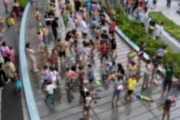 Blur background of many Thai and foreign tourists joining the fun Songkran festival in Thailand