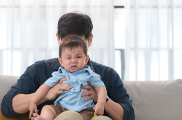 Fototapeta premium Father and son play together after dad comes home from work