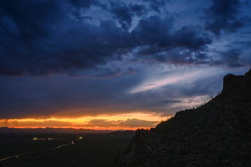 Stunning Mountain Sunset With Dramatic Clouds Over Desert Landscape