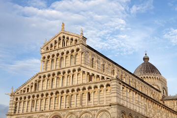 The intricately designed facade of the Pisa Cathedral, showcasing Romanesque architectural details...