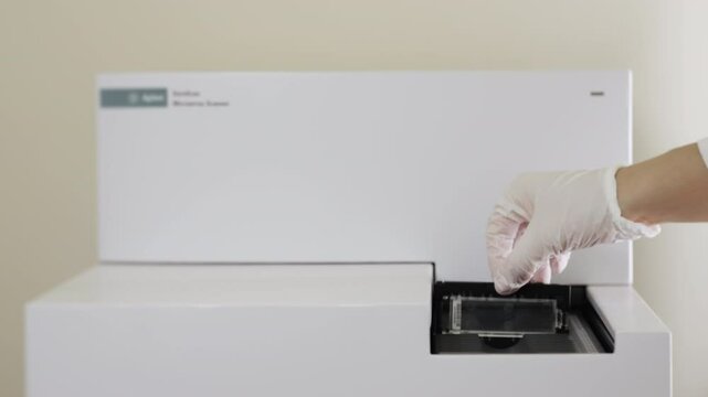 Loading a Microarray Slide into Laboratory Scanner.