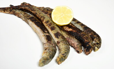 Fried lampreys on a plate and in a dish. Latvian lamprey recipes