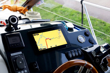 Motor boat steering panel view with steering wheel and navigation screen