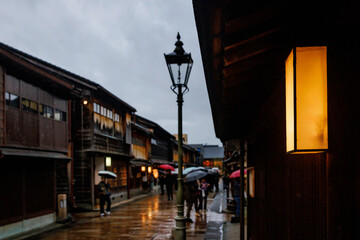 A Rainy Street in a Historic Town Featuring Lanterns and Colorful Umbrellas Waiting for You