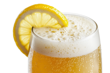 A refreshing glass of wheat beer with a cloudy appearance, topped with a thick, frothy white head. The glass is adorned with a slice of lemon on the rim, creating a vibrant and inviting look