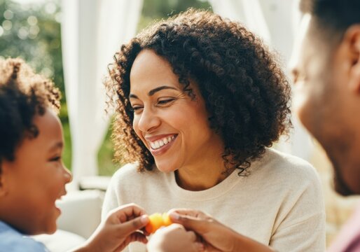 Mother sharing fruit with her son, enjoying quality time together outdoors