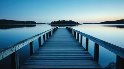 Fototapeta premium A serene wooden pier extending into calm waters at twilight.
