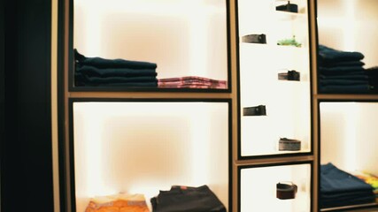 Luxury clothing store interior with organized displays, showcasing high-end fashion trends, wealth, status, and economic significance in the retail and luxury market industries