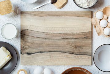 Multicolor wooden cutting board and baking ingredients