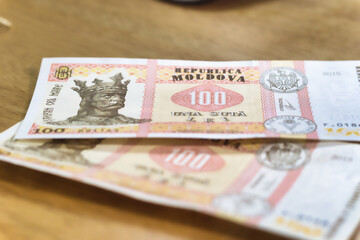 Moldovan 100 Leu Banknotes on Wooden Surface