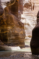 Jordan. Wadi Mujib. Wadi el-Mujib canyon with steep cliffs. Wadi Mujib River, also known as Arnon Stream, flows between high cliffs at bottom of narrow canyon among impressive rock formations.