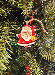 
New Year's toy on the Christmas tree. Macro photography of Santa Claus, New Year's toy and Christmas tree