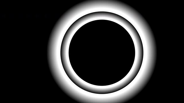 A mesmerizing animation of a glowing circle with a pulsating light effect against a black background, creating a hypnotic and visually engaging design.