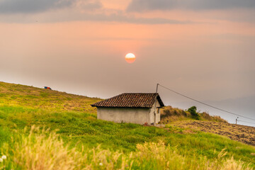 Sunset in the countryside with an intense red sun