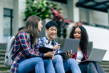 educational campus University students holding laptops talk or talk about exams, books, friends or outdoor variety.