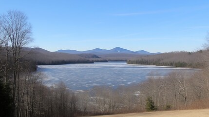 Frozen Lake and Mountain Range Under a Clear Blue Sky