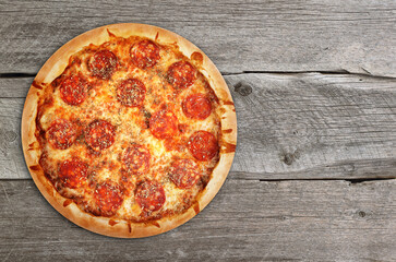 Pepperoni pizza on a wooden background