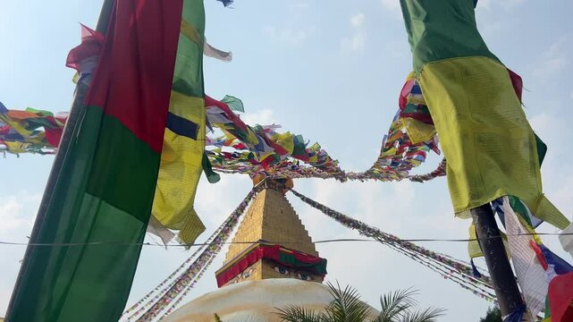Detail of the top of the largest Buddhist temple in Kathmandu. Many colourful flags with traditional prayers engraved on them, are waving