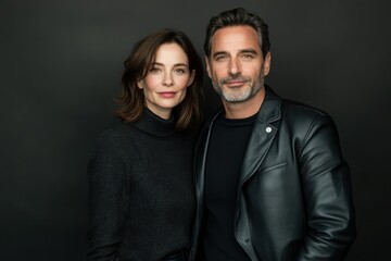 Fototapeta premium Actors pose together confidently in a stylish studio setting during an evening portrait session