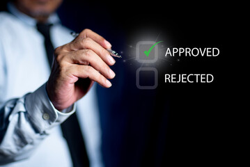 Businessman writing or tick correct mark to approve. check electronic documents on virtual screen....