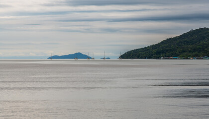 A captivating seascape showcasing dramatic clouds over a stunning island view in the distance
