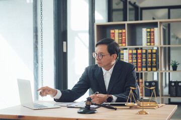 Focused Lawyer Reviewing Case Files: A meticulous lawyer, immersed in his work, carefully examines...