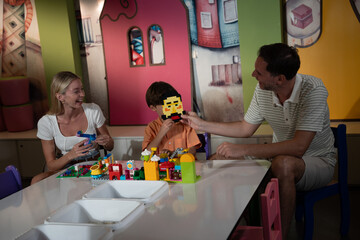  A happy family spending time at their child’s school, playing and having fun together.