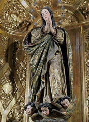 Praying Virgin Mary statue in Seville cathedral, Spain, 2024.
