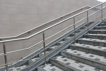 A modern staircase equipped with handrails situated within an urban environment setting