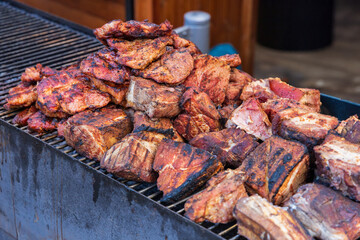 Street food. Grilled meat and side dish on a large pan for sale at the market