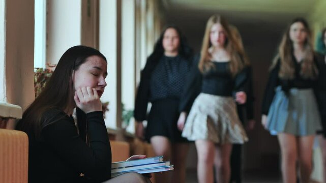 High school students consoling their upset classmate in the school hallway