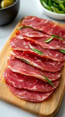 Obraz premium Slices of ham on wooden board.