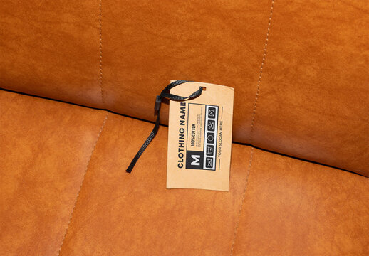 Hang Tag Resting on a Brown Leather Couch Cushion