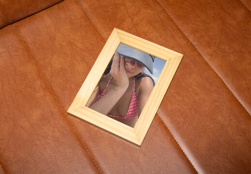 Wooden Frame on Brown Leather