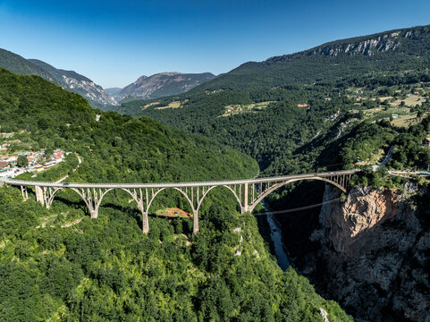 aerial view of durdevica Tara Bridge with tara river with blue water in mountains of montenegro