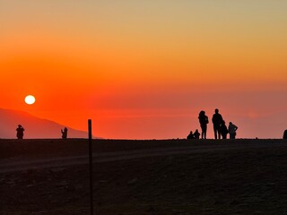 Sunset in the Andes with Silhouetted Figures