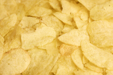 Textured background of crispy potato chips, ideal for design and branding purposes