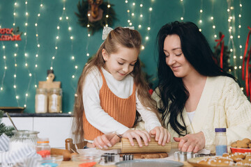 Fototapeta premium Mother and daughter making christmas cookies together