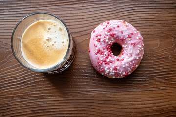 cup of coffee with pink donut