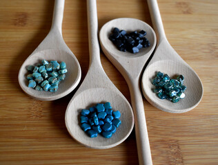 Beads of blue shades on wooden spoon