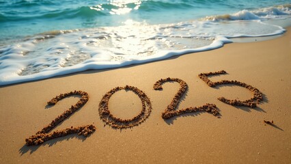 Fototapeta premium Sandy beach numbers mark the arrival of a new year by the serene waters of the coastline