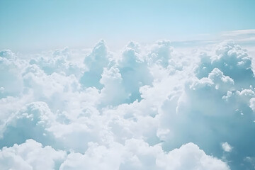 Photo of fluffy white clouds in the sky, with clear blue skies in the background.