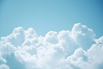 Photo of fluffy white clouds in the sky, with clear blue skies in the background.