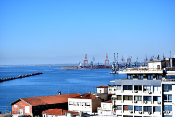 Port cranes in the morning.Ships and cranes at Thessaloniki, Greece port.