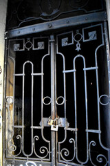 A padlock  hanging on an old iron door