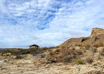 a derelict abandoned home in the distance amid the dry desert landscape of big bend national park, texas, usa