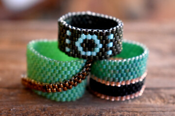 Beaded rings isolated on a wood surface